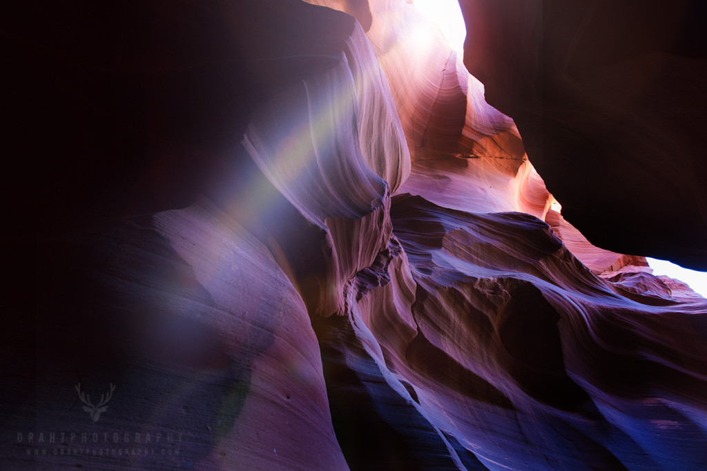 A slot of light coming through a peak in Antelope Canyon